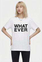 Load image into Gallery viewer, Model is wearing a white t-shirt with 'WHAT EVER' text on a plain background
